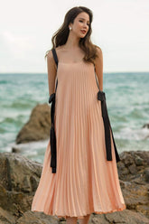 Pleated silk midi dress with ribbon tie straps and flowing A-line silhouette for elegant movement